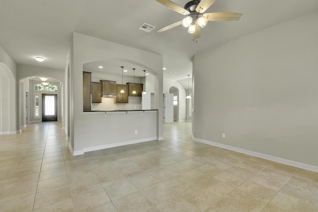 interior space with light tile patterned floors and ceiling fan