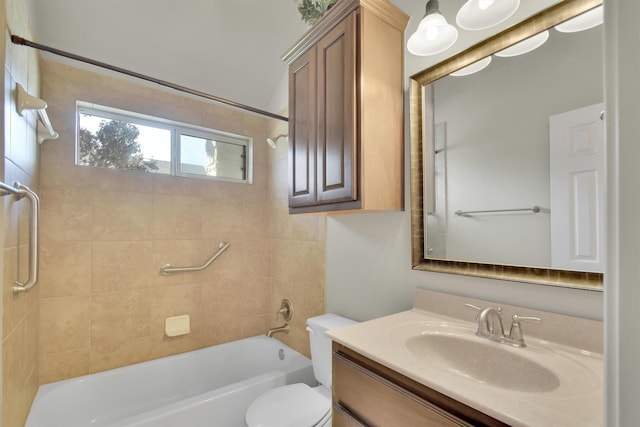 full bathroom with vanity, tiled shower / bath, and toilet