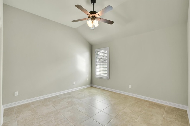 empty room featuring vaulted ceiling, ceiling fan, and light tile patterned flooring