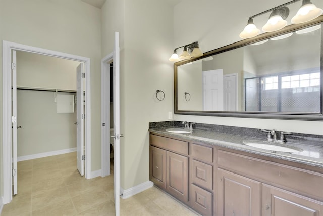 bathroom featuring vanity, tile patterned flooring, and a shower with door