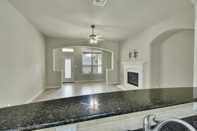 interior space with ceiling fan