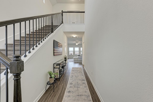 interior space with a towering ceiling and hardwood / wood-style floors