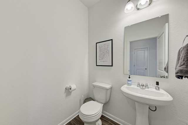 bathroom featuring hardwood / wood-style floors, sink, and toilet