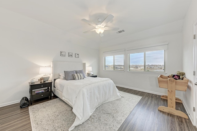 bedroom with dark hardwood / wood-style floors and ceiling fan