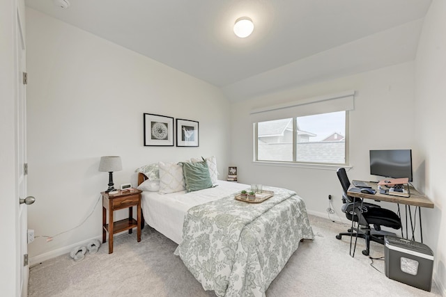 bedroom with vaulted ceiling and light colored carpet