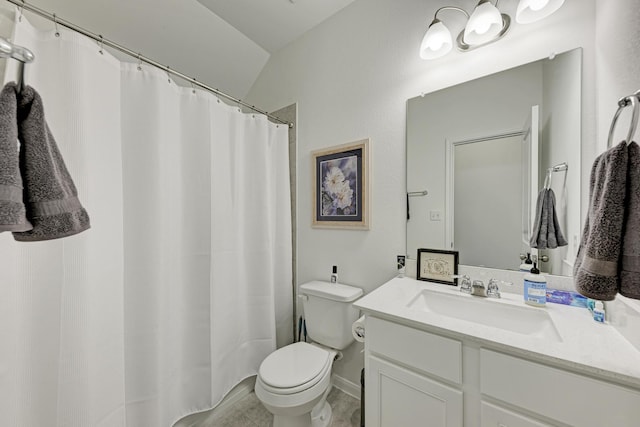 bathroom with lofted ceiling, vanity, and toilet