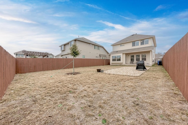 rear view of property featuring a yard and a patio