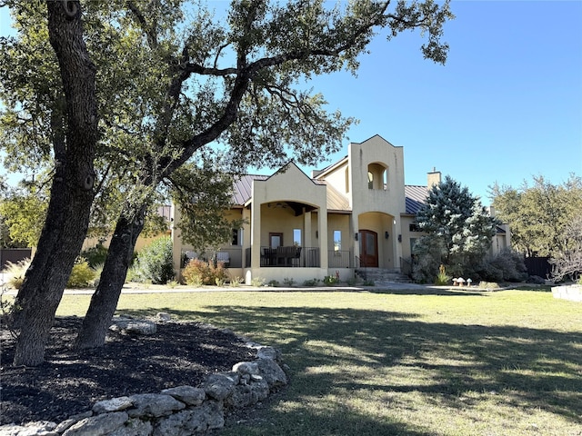 view of front of house with a front yard and covered porch