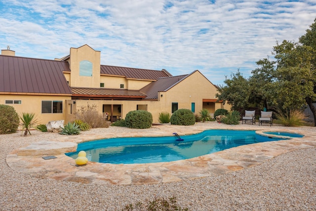 view of swimming pool featuring a patio area and an in ground hot tub