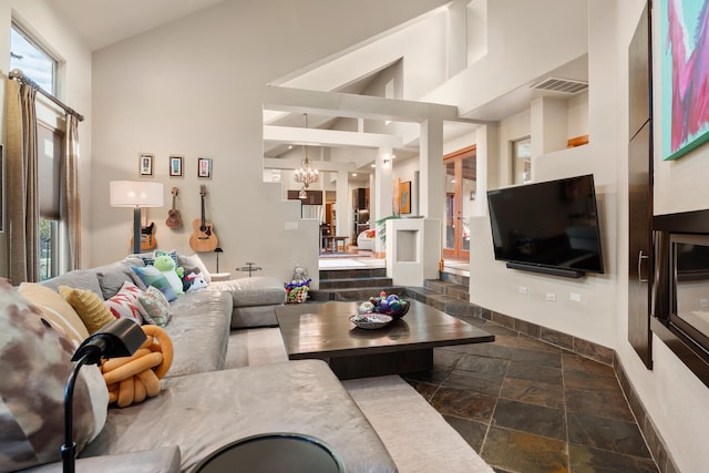 living room with lofted ceiling and a chandelier