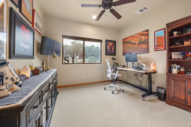 carpeted office featuring ceiling fan