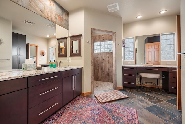 bathroom with a shower and vanity