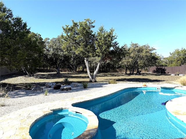 view of swimming pool featuring an in ground hot tub