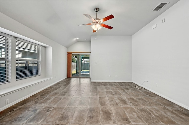 empty room featuring lofted ceiling and ceiling fan