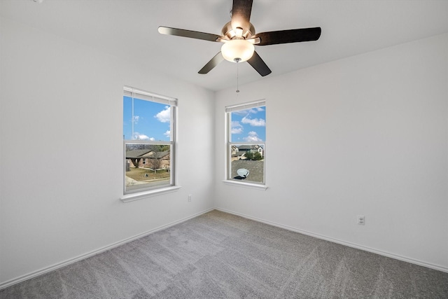 carpeted empty room featuring ceiling fan