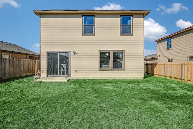 rear view of house featuring a yard