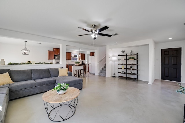 living room featuring concrete flooring and ceiling fan