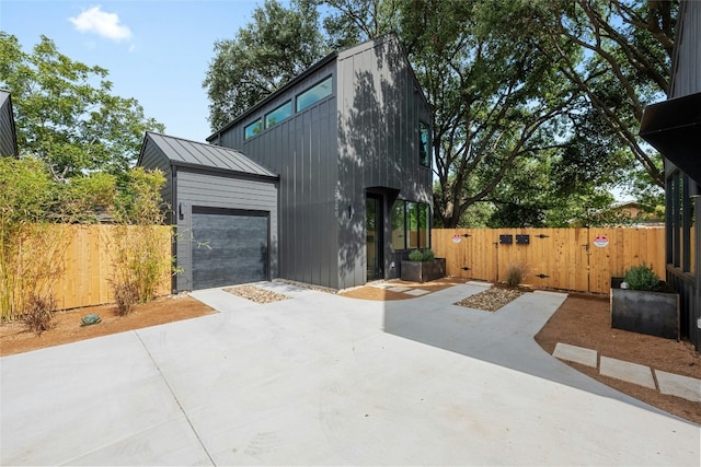 2010 Gathright Unit B, Austin, TX 78704 - view of home's exterior with a standing seam roof, a gate, driveway, a metal roof, and a garage