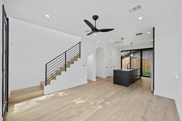 2010 Gathright Unit B, Austin, TX 78704 - unfurnished living room with stairs, a ceiling fan, light wood-style floors, and recessed lighting