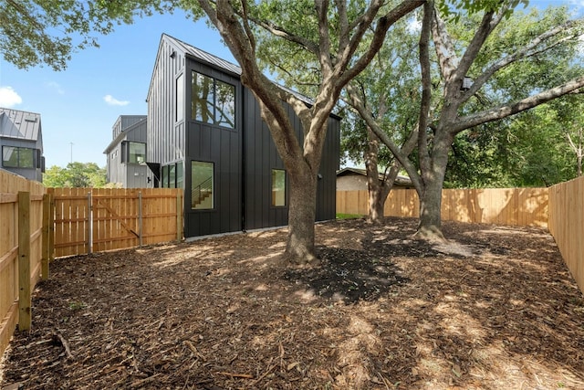 2010 Gathright Unit B, Austin, TX 78704 - rear view of property featuring board and batten siding and a fenced backyard
