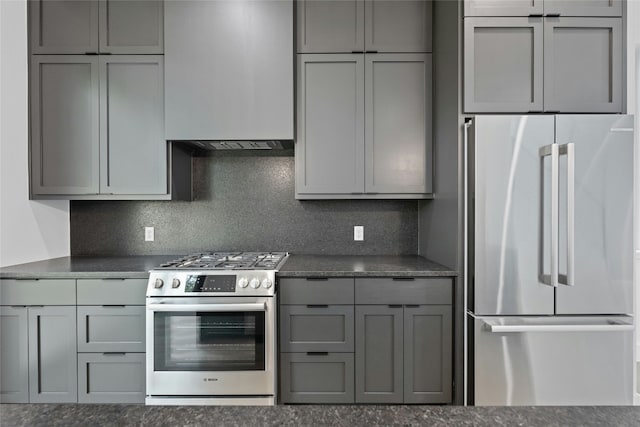 2010 Gathright Unit B, Austin, TX 78704 - kitchen featuring appliances with stainless steel finishes, gray cabinets, backsplash, and dark stone countertops