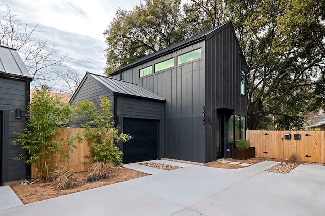 2010 Gathright Unit B, Austin, TX 78704 - view of front of property with a gate, a garage, a standing seam roof, driveway, and board and batten siding