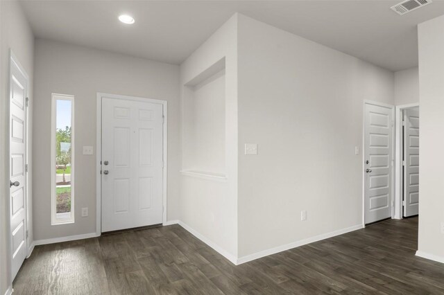199 Lavender Ln, Elgin, TX 78621 - entrance foyer with baseboards, visible vents, and dark wood finished floors