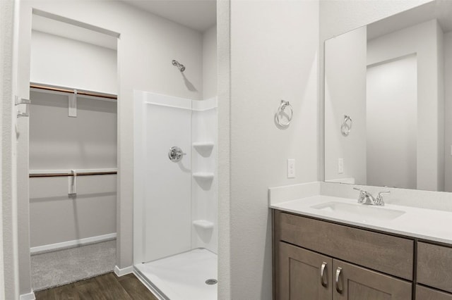 199 Lavender Ln, Elgin, TX 78621 - full bath with vanity, wood finished floors, a stall shower, and a spacious closet