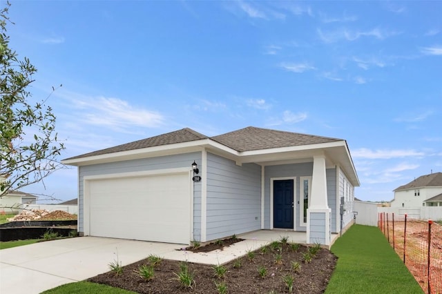 199 Lavender Ln, Elgin, TX 78621 - single story home featuring driveway, a shingled roof, an attached garage, and fence
