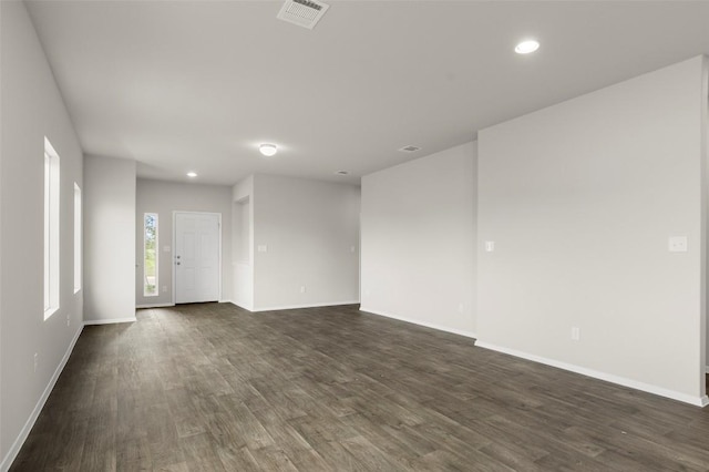 199 Lavender Ln, Elgin, TX 78621 - empty room with dark wood-style flooring, visible vents, baseboards, and recessed lighting