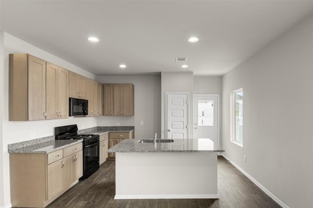 199 Lavender Ln, Elgin, TX 78621 - kitchen featuring a kitchen island with sink, a sink, black appliances, and dark wood-style floors