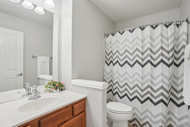 bathroom with vanity, toilet, and a shower with curtain