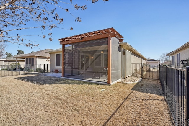 rear view of house with a patio and a lawn