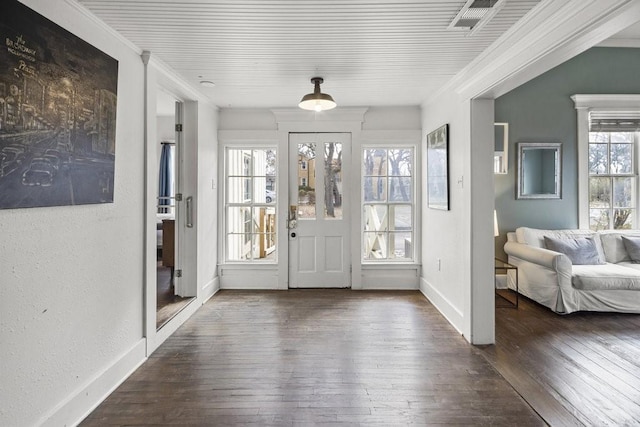 entryway featuring ornamental molding and dark hardwood / wood-style floors