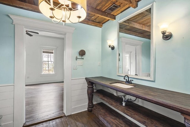 bathroom featuring sink, an inviting chandelier, wooden ceiling, beamed ceiling, and hardwood / wood-style floors