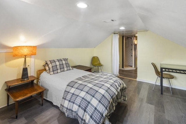 bedroom featuring dark wood-type flooring and vaulted ceiling