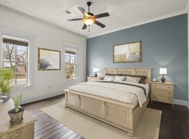 bedroom with multiple windows, dark hardwood / wood-style floors, and ceiling fan