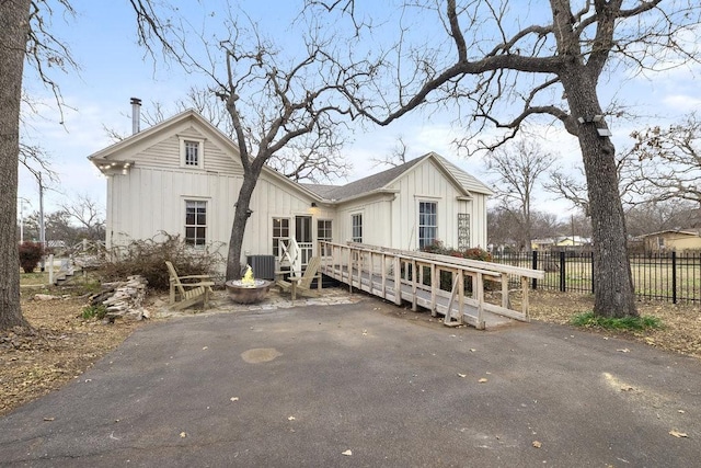 view of front of house with a wooden deck and central air condition unit