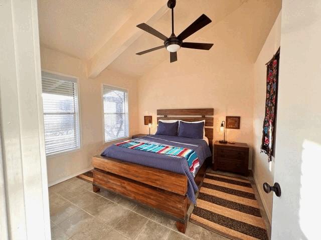 bedroom featuring vaulted ceiling with beams and ceiling fan