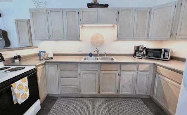 kitchen with dark tile patterned flooring, sink, and electric range oven