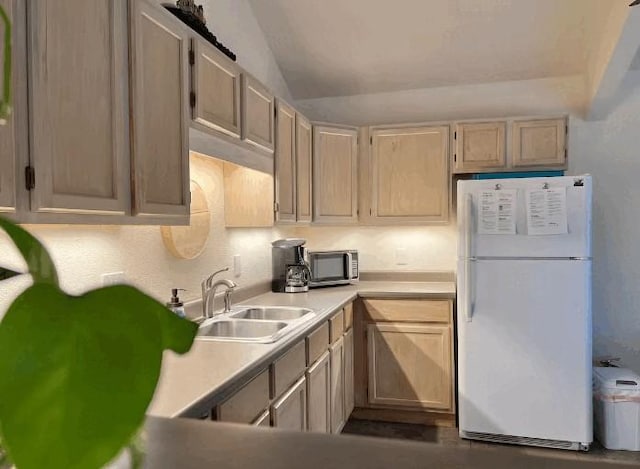 kitchen featuring white fridge, sink, and light brown cabinets