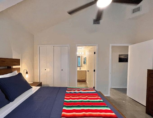 bedroom with ensuite bathroom, high vaulted ceiling, ceiling fan, and a closet