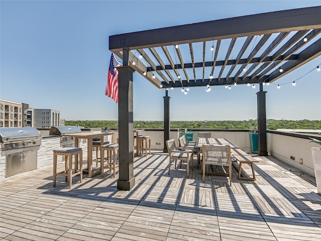 view of patio / terrace with area for grilling, exterior bar, and a pergola