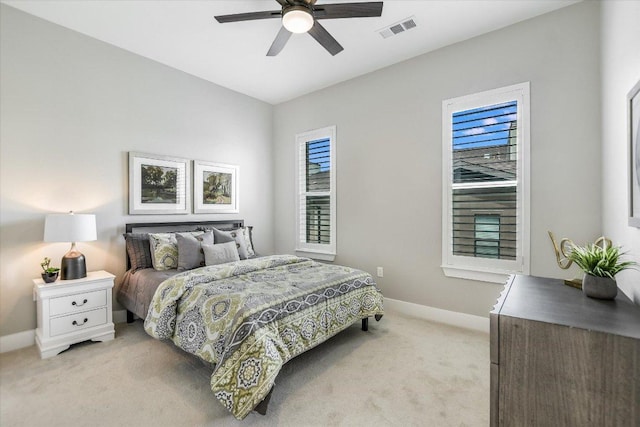 bedroom with visible vents, baseboards, and light carpet