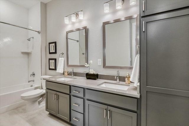 full bathroom with double vanity, toilet, tub / shower combination, and a sink