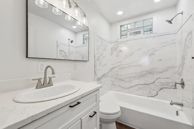 full bathroom featuring vanity, bathtub / shower combination, and toilet