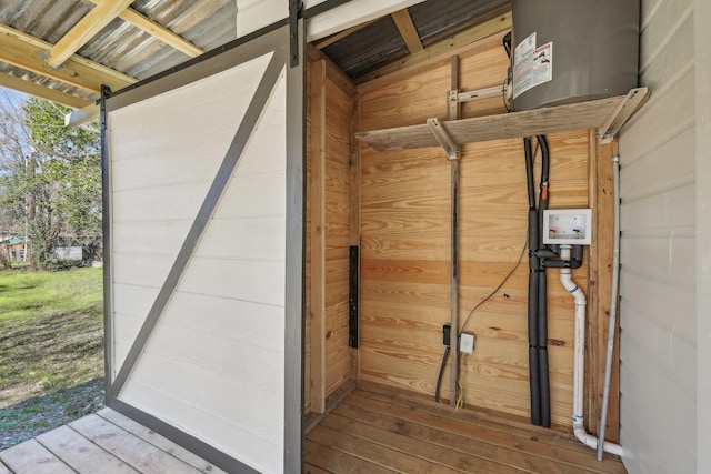 interior details with a barn door and wood walls