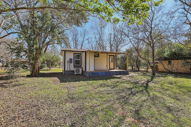 view of outdoor structure featuring a yard and ac unit