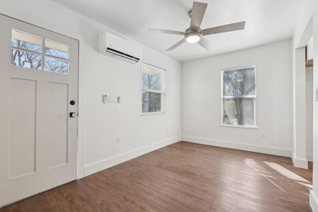 entryway with a wealth of natural light, dark hardwood / wood-style floors, a wall mounted AC, and ceiling fan