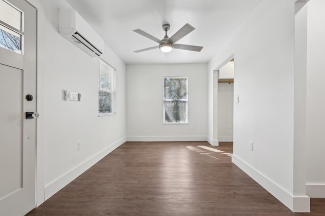 interior space with ceiling fan, dark hardwood / wood-style floors, and a wall mounted AC